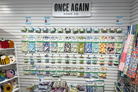Once Again Home Co. reusable paper towels and eco cloths arranged on a retail wall display